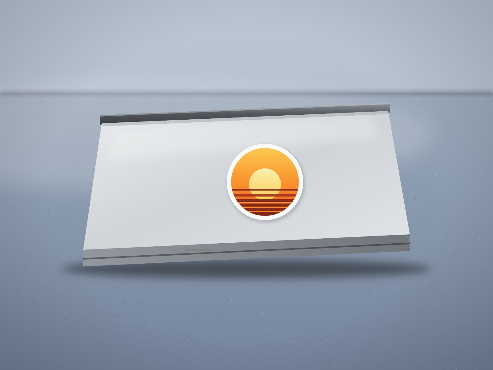 Silver laptop with a round orange sticker